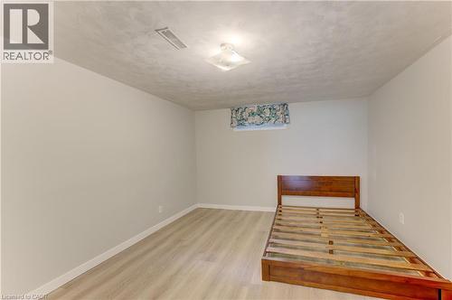 Light wood-finish flooring, neutral wall tones, and overhead flush-mount lighting - 64 Stanley Street, Cambridge, ON 