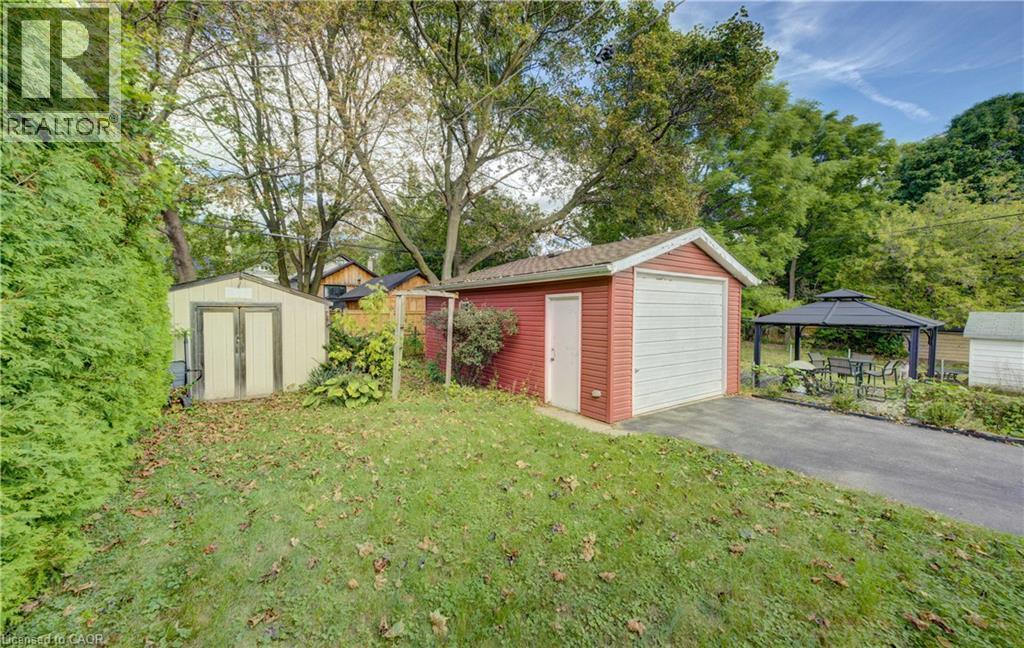 Detached garage, asphalt driveway, separate storage shed, established landscaping, and a gazebo - 64 Stanley Street, Cambridge, ON