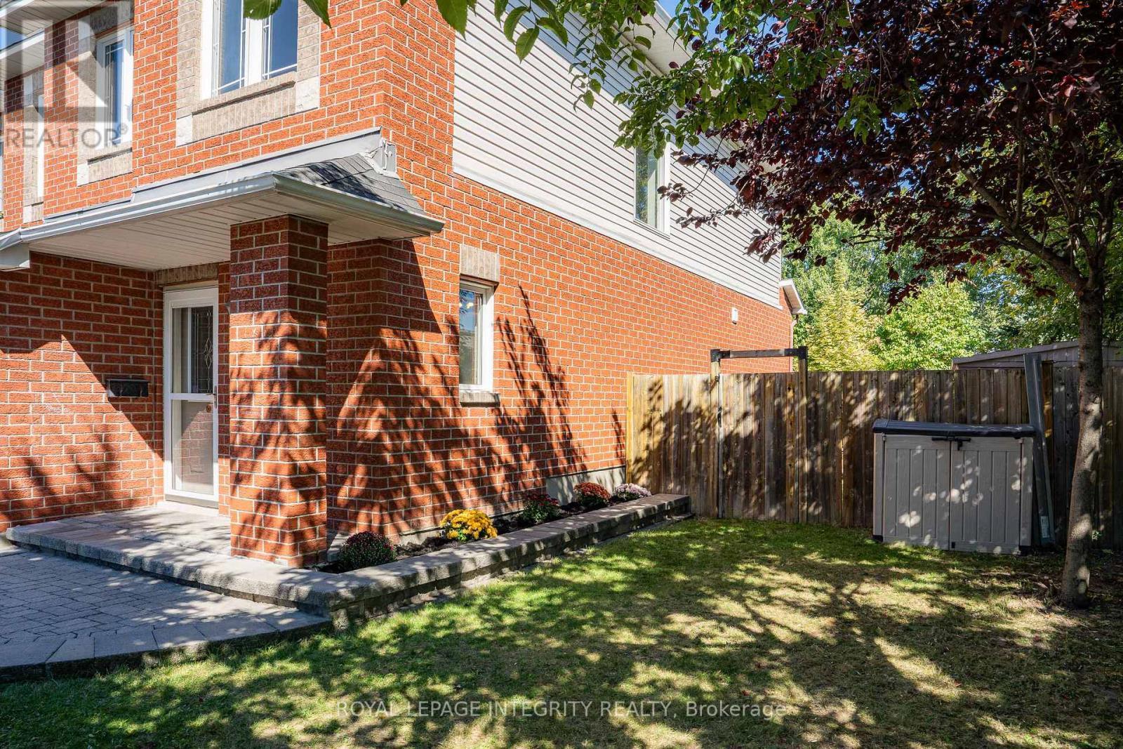 Fully fenced backyard with mature trees - 170 Flamborough Way, Ottawa, ON