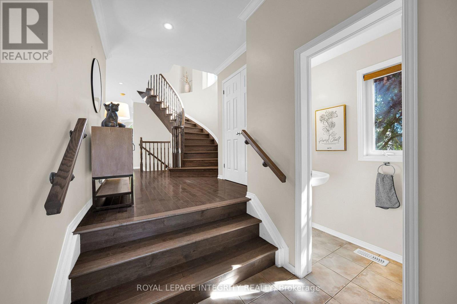 Bright foyer with curved wood staircase - 170 Flamborough Way, Ottawa, ON