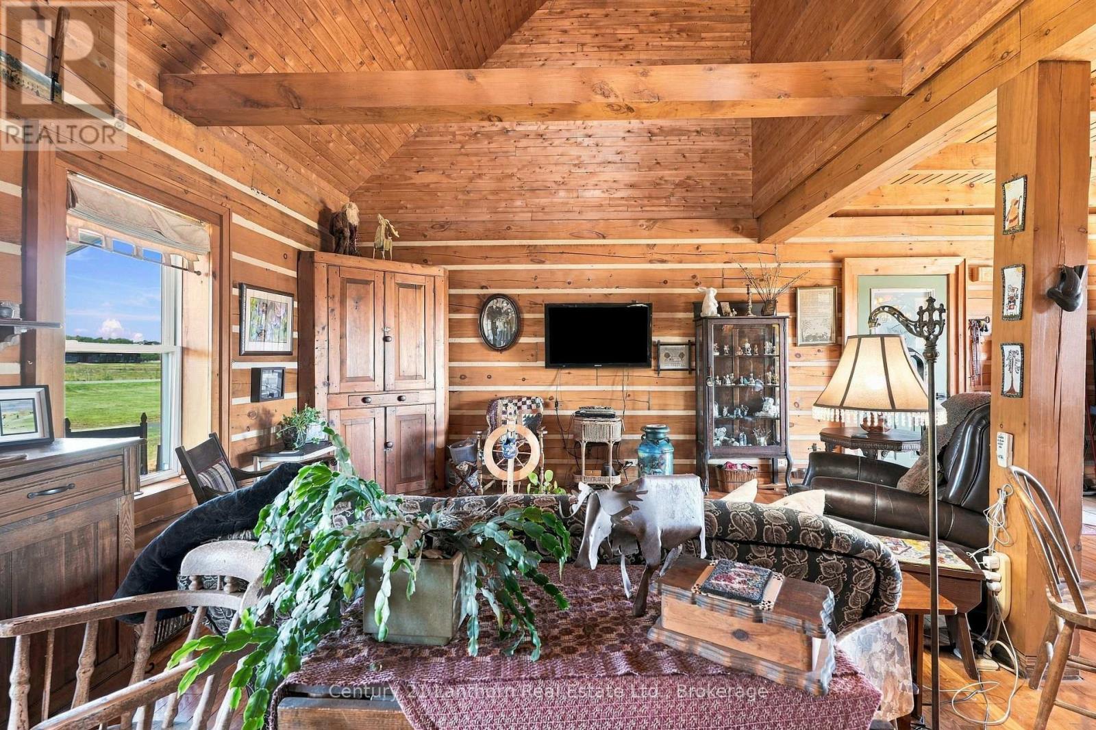 Living room with cathedral ceiling - 939 Kelly Road, Prince Edward County (Athol Ward), ON