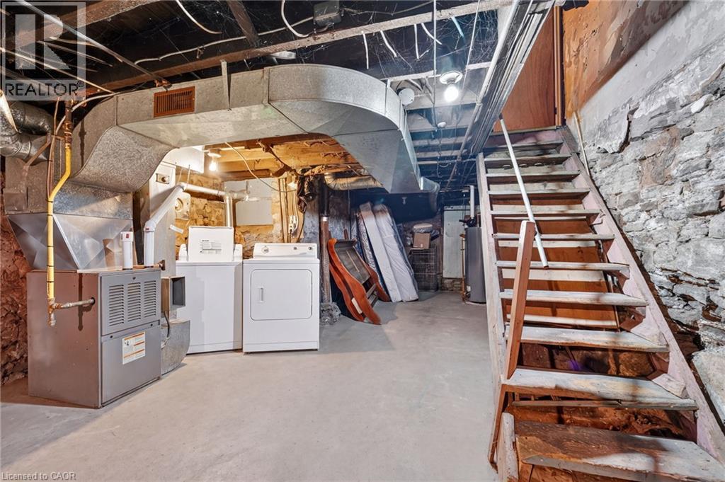 Concrete flooring and exposed stone foundation walls - 199 N Locke Street N, Hamilton, ON