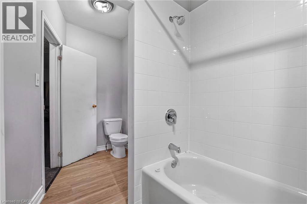 White subway tile shower surround with chrome fixtures - 199 N Locke Street N, Hamilton, ON