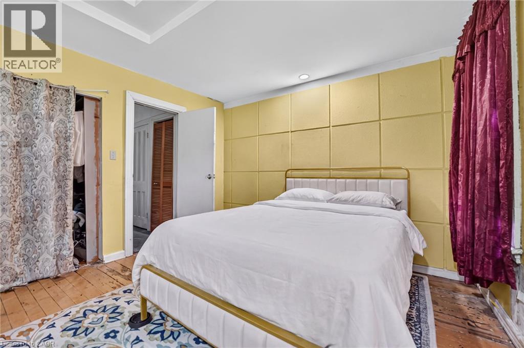 Recessed lighting, crown molding, paneled wall accent, and a white interior door - 199 N Locke Street N, Hamilton, ON