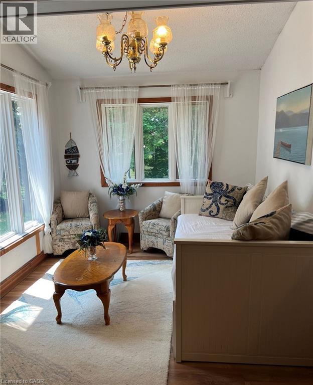 Wood-finish flooring, multiple windows, and a classic brass chandelier - 16431 Highway 35, Algonquin Highlands, ON