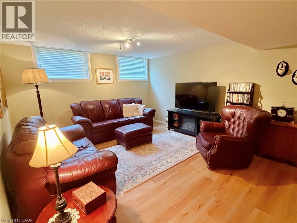 Wood-finish flooring with recessed lighting and two egress windows - 40 Stornoway Crescent, Huron East, ON