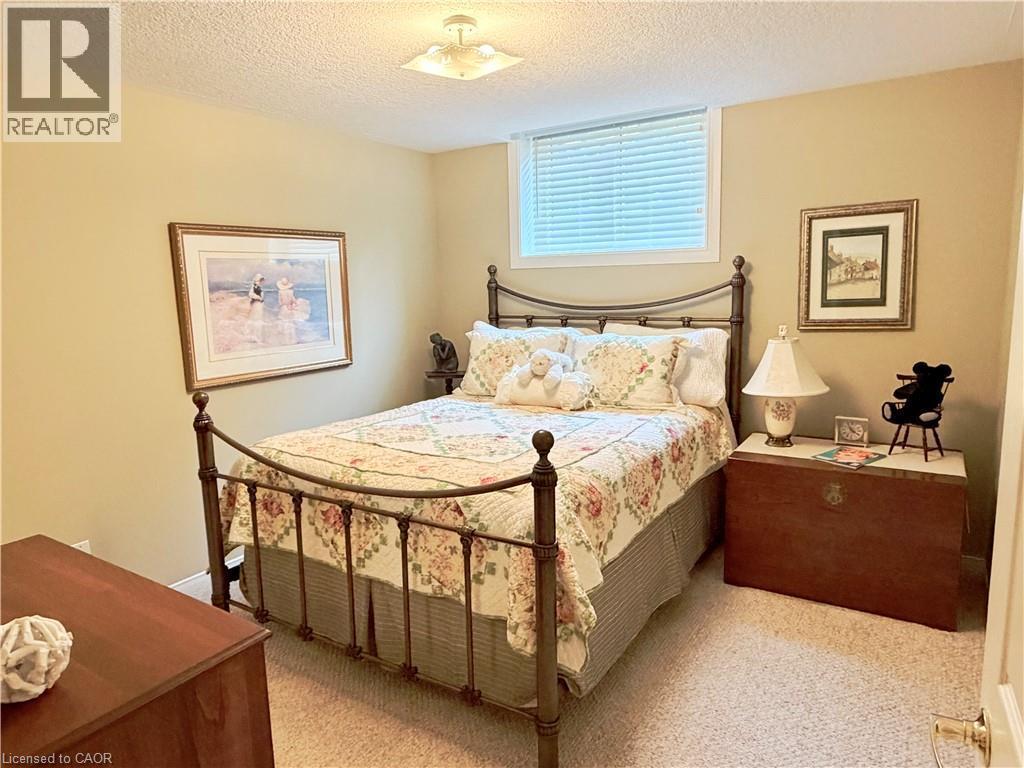 Carpeted flooring, window with blinds, and ceiling-mounted light fixture - 40 Stornoway Crescent, Huron East, ON