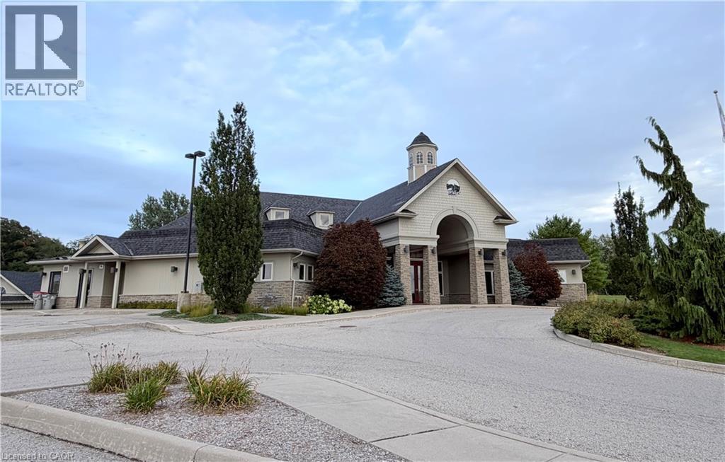 Architectural structure featuring a central cupola, prominent arched entryway, and stone veneer accents - 40 Stornoway Crescent, Huron East, ON