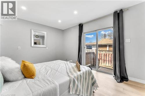 Recessed ceiling lighting, wood-finish flooring, sliding glass door, and a private attached wood deck - 101 Emerald Street N, Hamilton, ON 