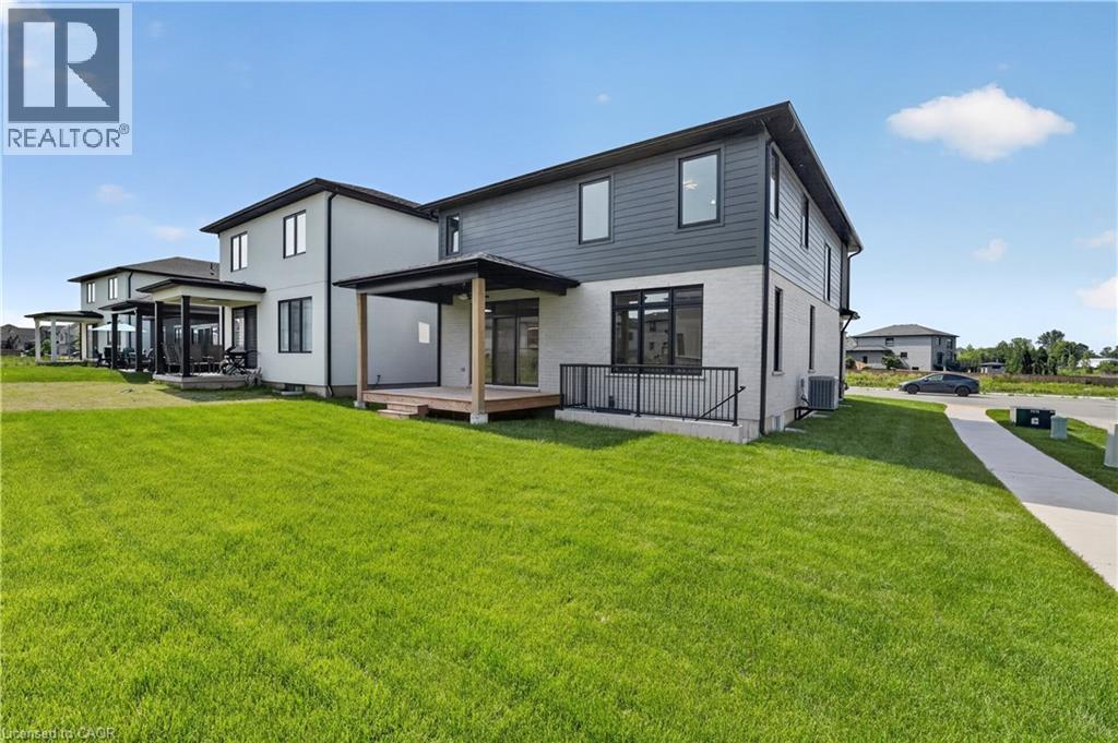 Modern exterior featuring a covered deck, black railings, and a multi-toned facade with vertical and horizontal siding - 8905 Angie Drive, Niagara Falls, ON