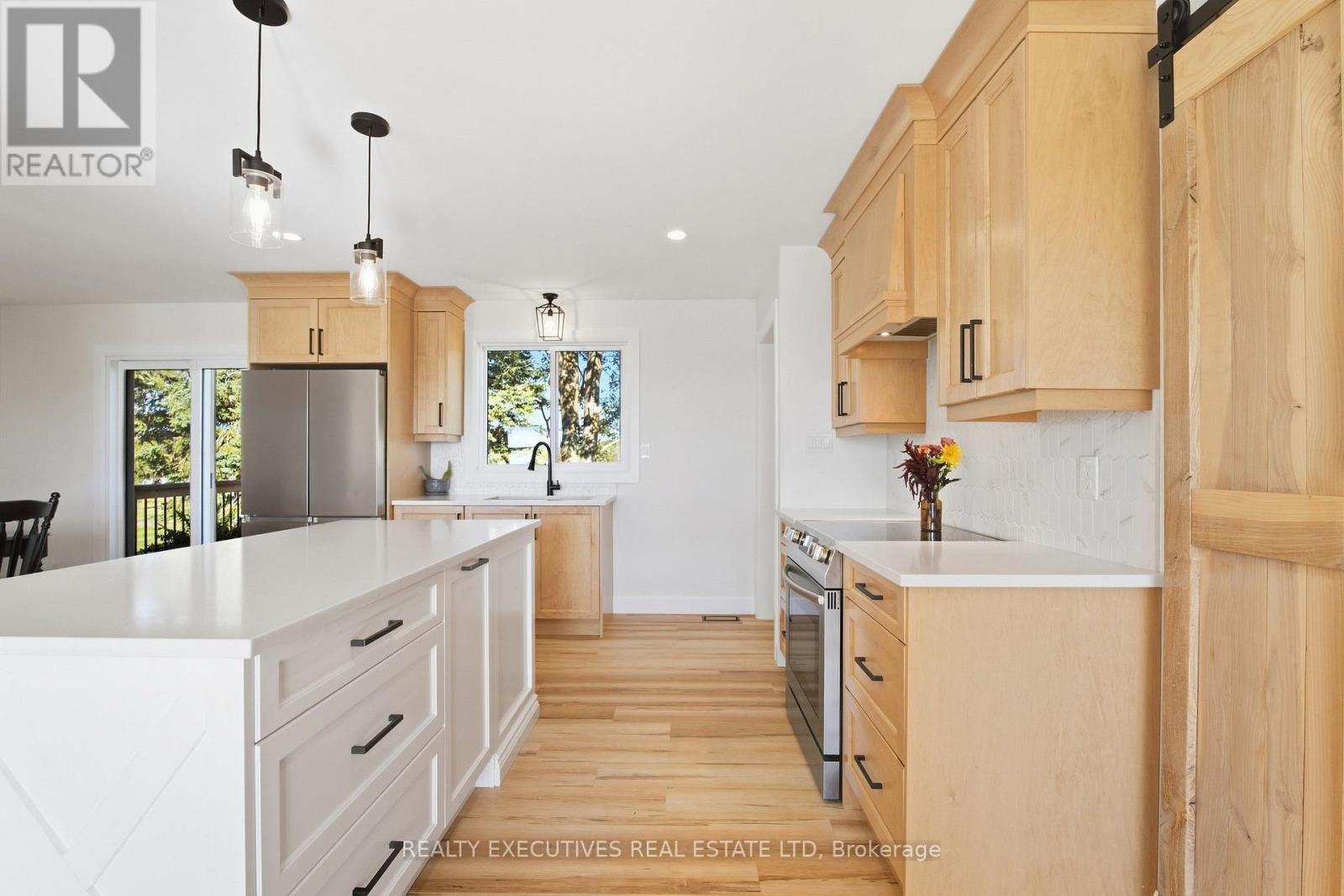 Modern pendant lighting over island - 11895 Cloverdale Road, North Dundas, ON
