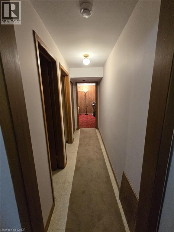 Hallway featuring a ceiling-mounted light fixture, and wood-finish door frames - 410 Lakeview Drive, Waterloo, ON