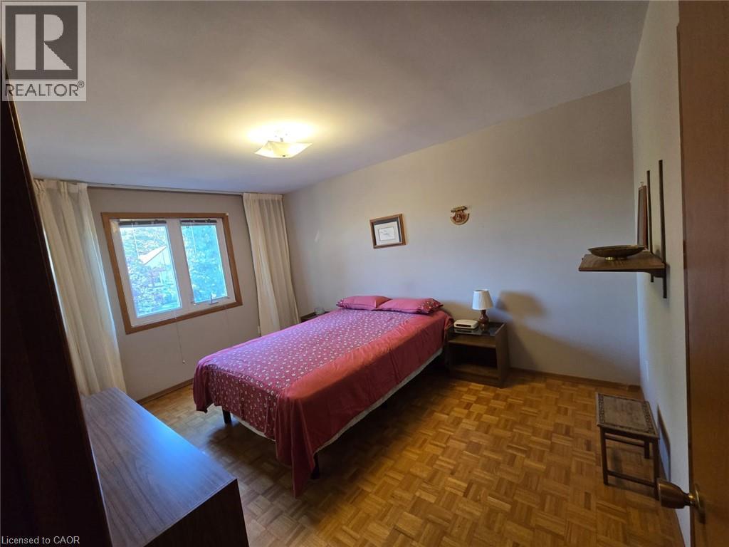 Window with wood trim, parquet wood flooring, and sloped ceiling - 410 Lakeview Drive, Waterloo, ON