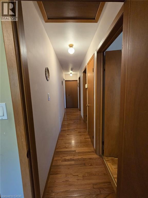Wood-finish flooring with multiple flush-mount ceiling lights - 410 Lakeview Drive, Waterloo, ON