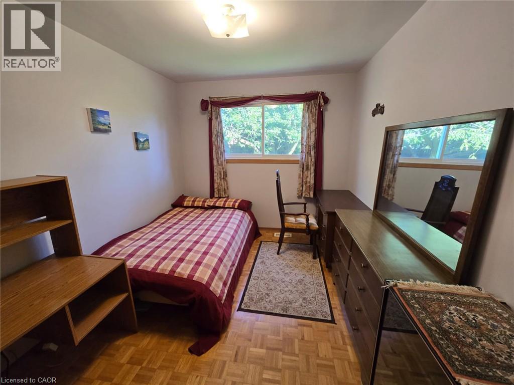 Parquet wood flooring, a window with natural light, and an overhead light fixture - 410 Lakeview Drive, Waterloo, ON