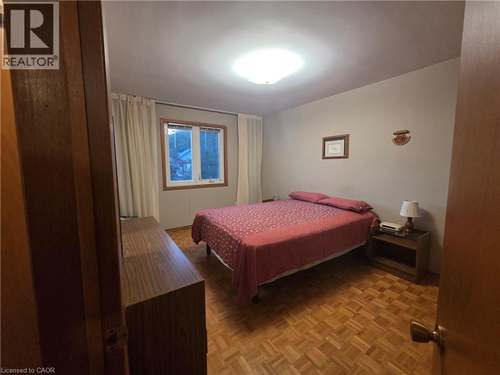 Parquet wood-finish flooring, white window casing, and a flush-mount ceiling light - 410 Lakeview Drive, Waterloo, ON