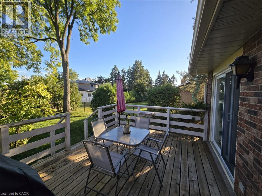 Expansive wood deck with horizontal railing, featuring direct access via a sliding glass door - 410 Lakeview Drive, Waterloo, ON