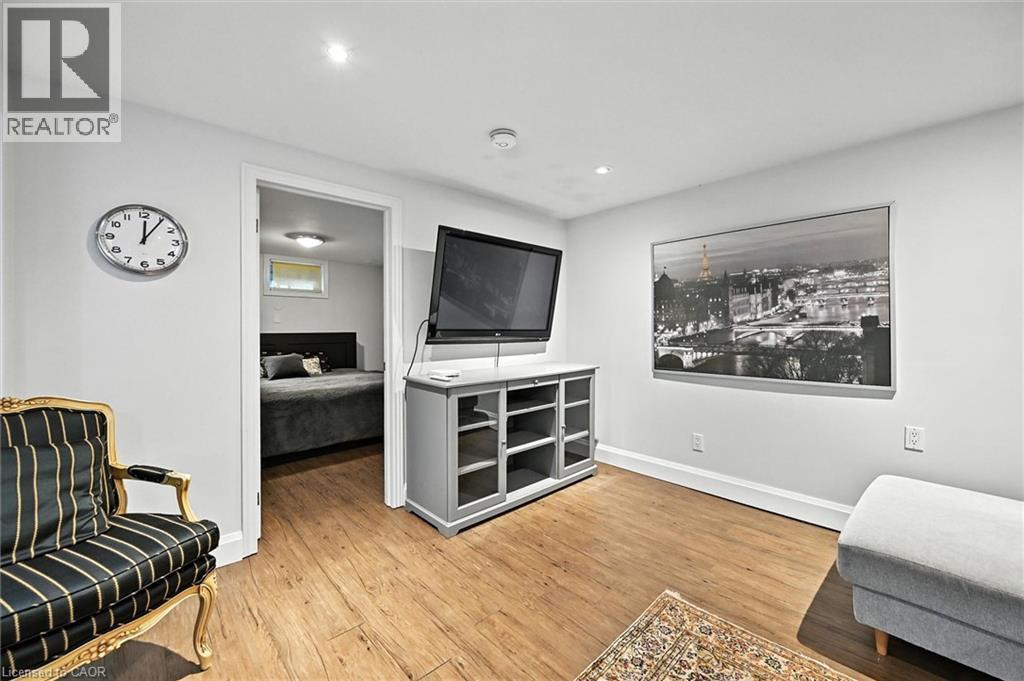 Wood-finish flooring with white baseboards, recessed ceiling lighting, and a neutral wall color - 2209 Ghent Avenue, Burlington, ON