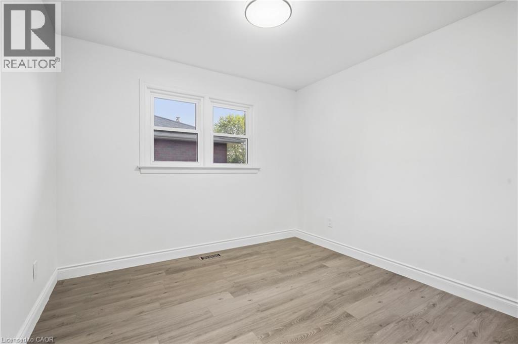 Recessed ceiling light, dual-pane window, wood-finish flooring, and white trim - 49 Beverly Crescent, Welland, ON