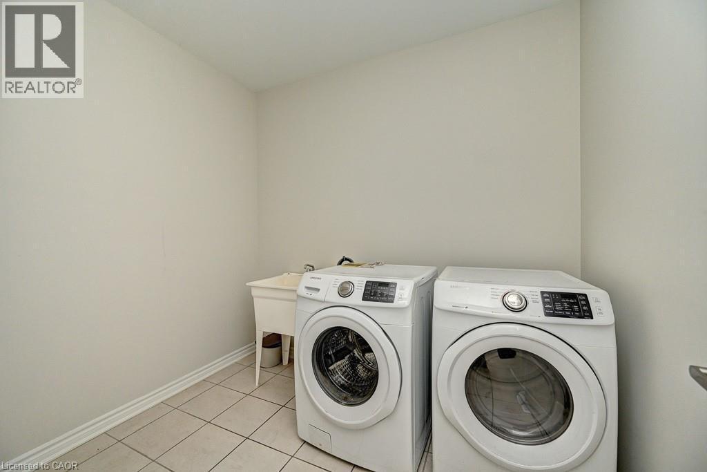 Laundry area with tiled flooring and a utility sink - 236 Ridge Road, Cambridge, ON