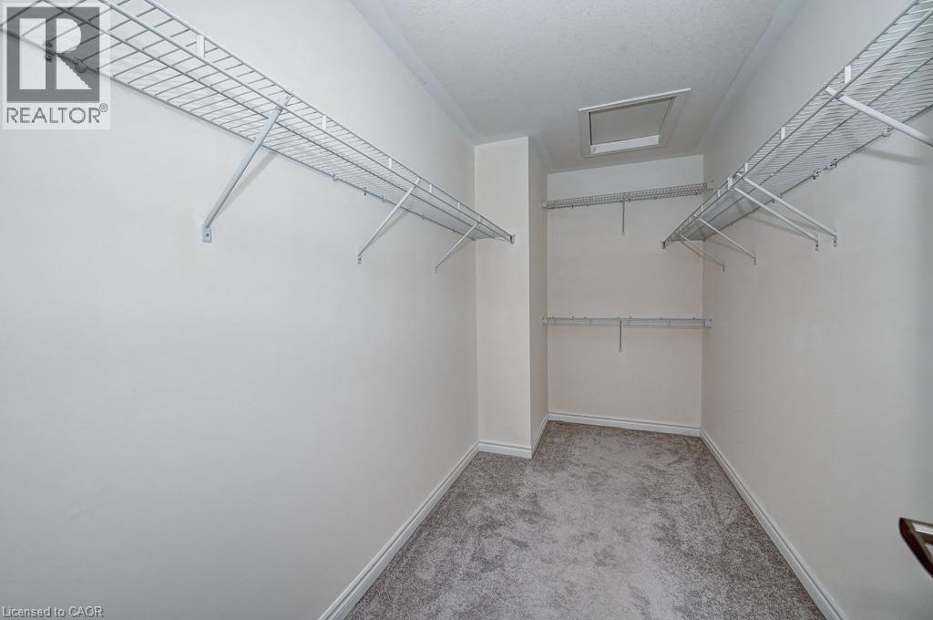 Walk-in closet featuring wire shelving, white walls, and carpet flooring - 236 Ridge Road, Cambridge, ON