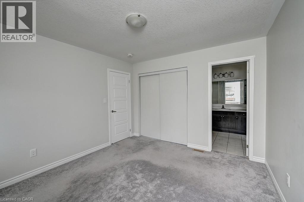 Light gray carpeting, white walls, and a ceiling-mounted light fixture - 236 Ridge Road, Cambridge, ON