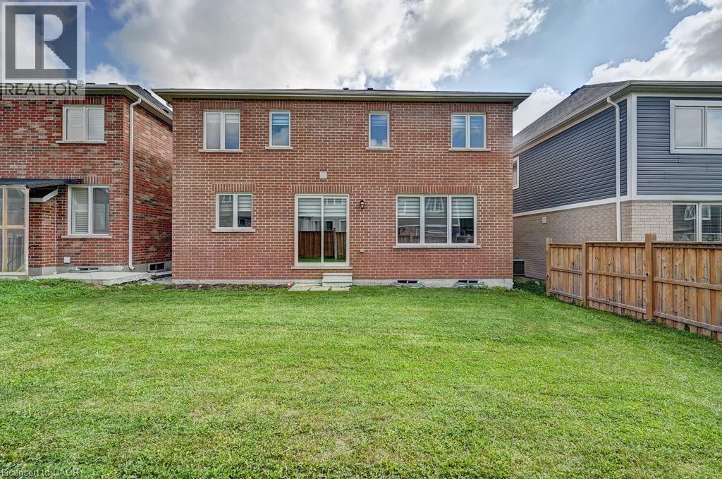 Red brick exterior with multiple windows and a sliding glass door - 236 Ridge Road, Cambridge, ON