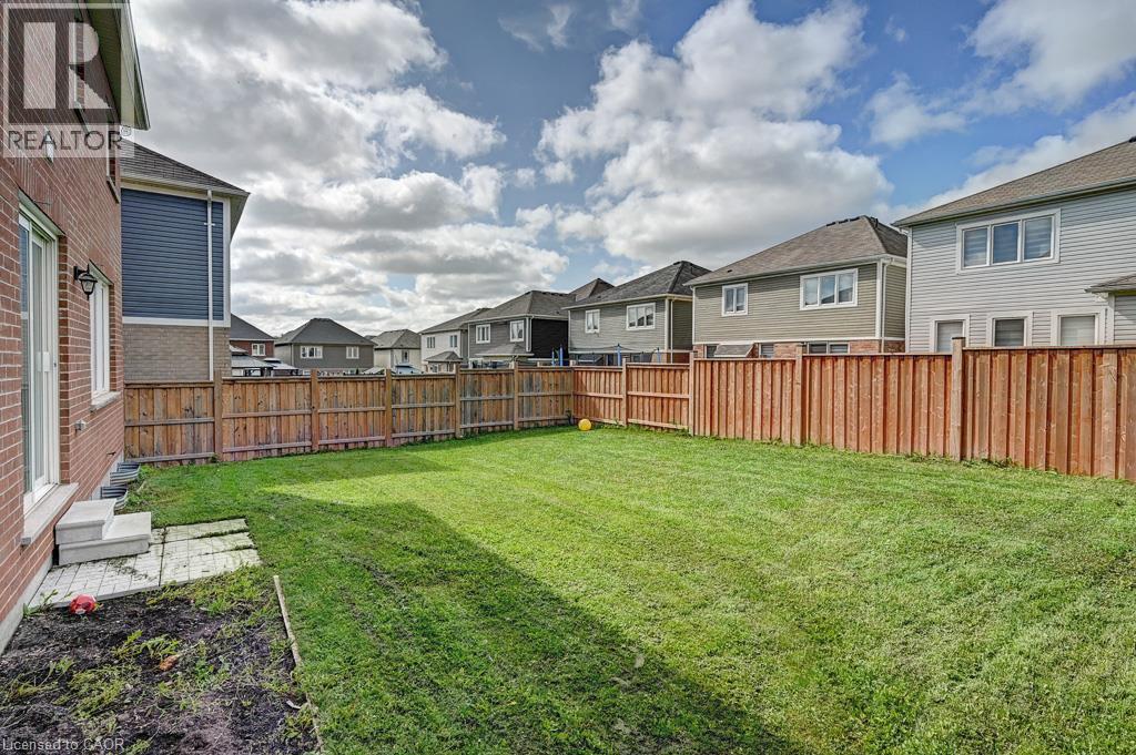 Expansive fenced backyard featuring a manicured lawn - 236 Ridge Road, Cambridge, ON