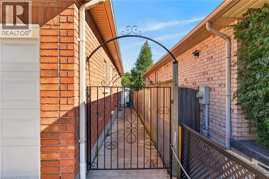 Brick exterior with white garage door - 795 Tenth Avenue, Hamilton, ON