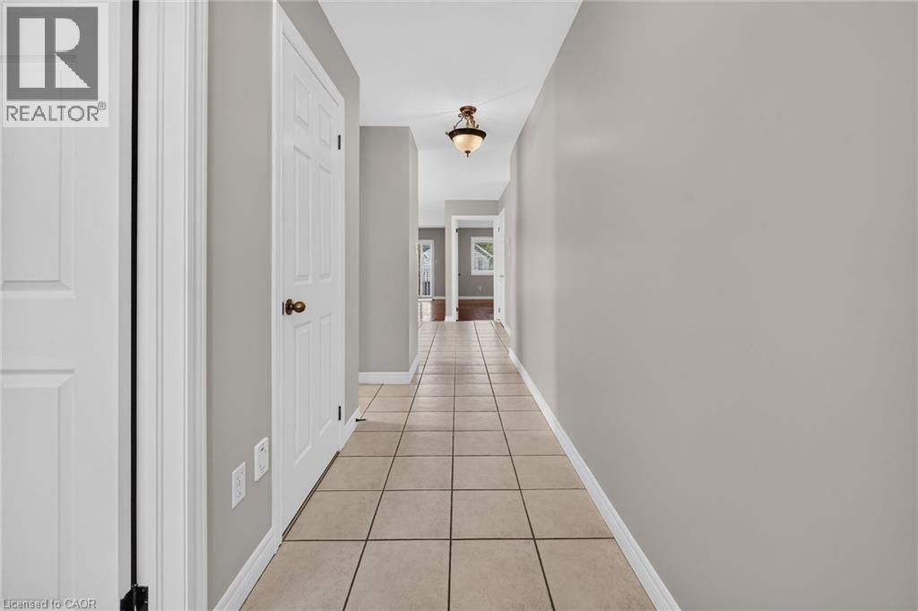 Tile flooring throughout, neutral wall tones, white interior doors, and overhead lighting fixtures - 795 Tenth Avenue, Hamilton, ON