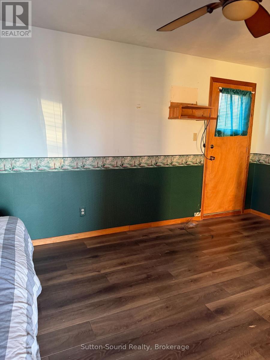 primary bedroom with a back deck - 108 Wilson Drive, Georgian Bluffs, ON