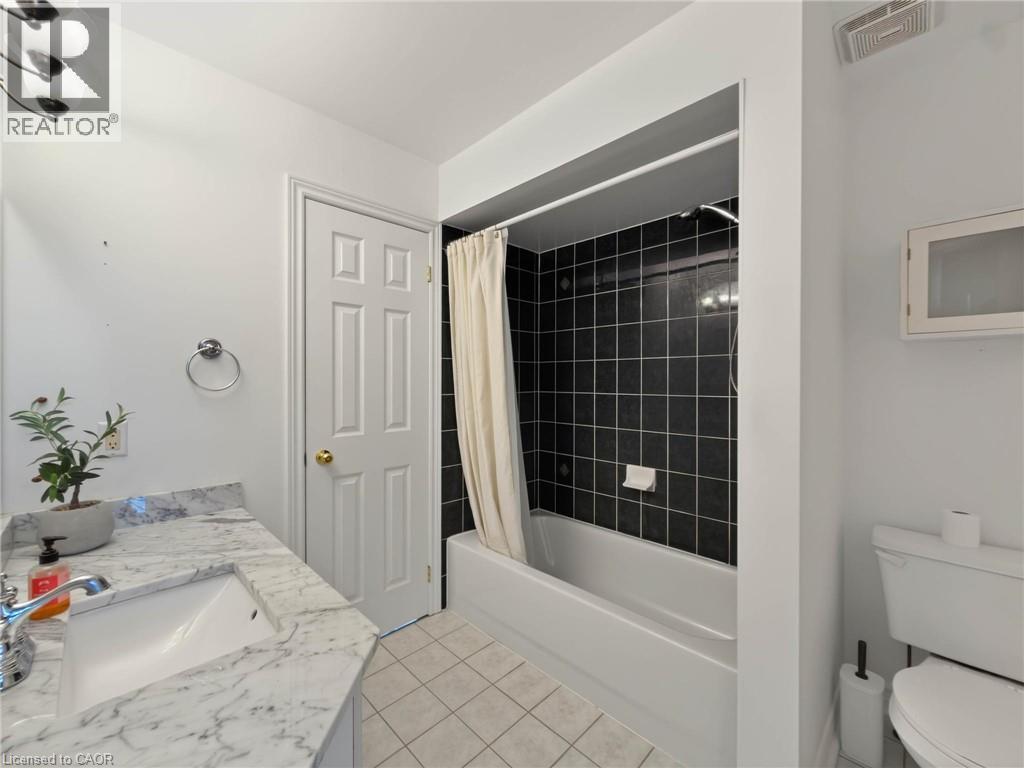 White single vanity with an integrated rectangular sink and a gray-veined countertop - 74 Davidson Boulevard, Dundas, ON