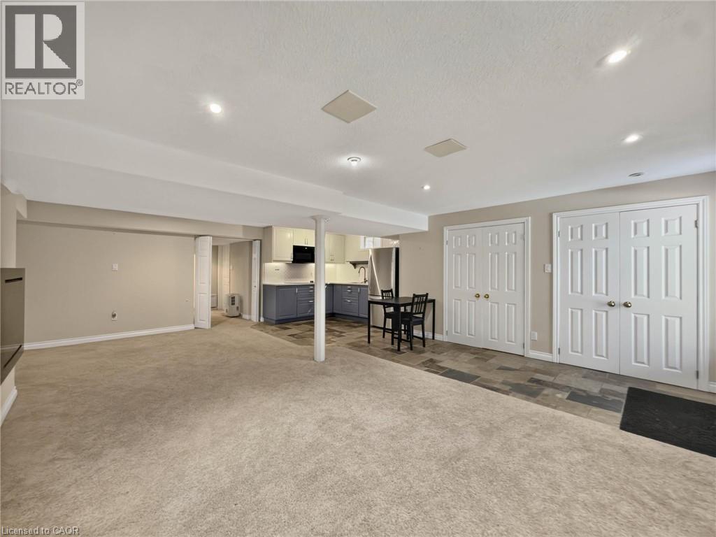 Recessed lighting, wood-finish flooring, two sets of double-door closets, and a built-in kitchen with under-cabinet lighting - 74 Davidson Boulevard, Dundas, ON