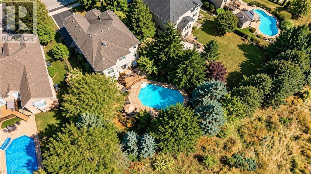 Property featuring an inground swimming pool, expansive rear deck, and mature landscaping - 74 Davidson Boulevard, Dundas, ON