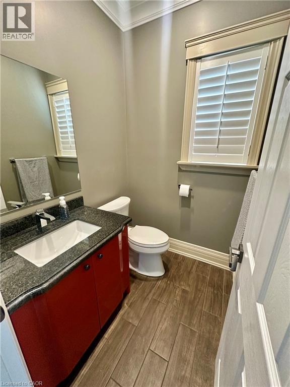 Wood-finish tile flooring, white window shutters, and crown molding - 5 Arden Avenue, Hamilton, ON