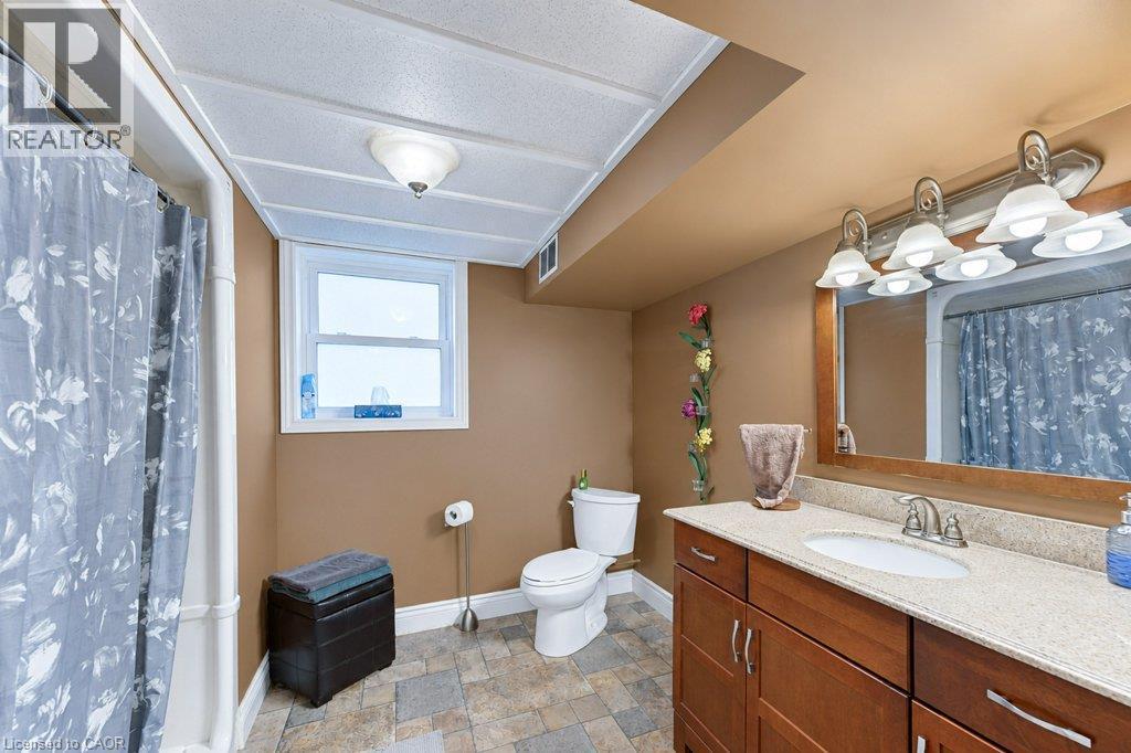 Functional bathroom featuring a shower enclosure, vanity with integrated sink, and vanity mirror - 34 Wayne Drive, Kitchener, ON