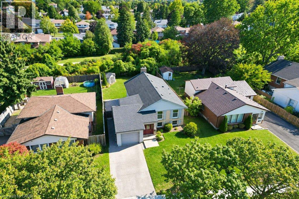 Aerial perspective showcasing a residential property with a sloped roof, an attached garage, a paved driveway, and a manicured lawn - 34 Wayne Drive, Kitchener, ON