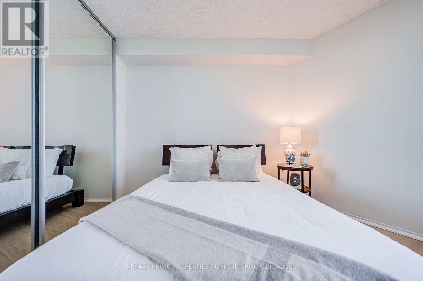 Bedroom with mirrored closet door. - 301 - 250 Queens Quay W, Toronto, ON