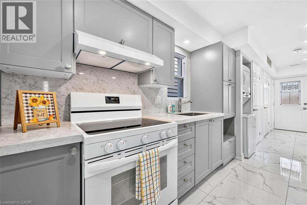 White electric range with an integrated oven, gray shaker-style cabinetry, and light-toned countertops - 4 Albemarle Street, Hamilton, ON
