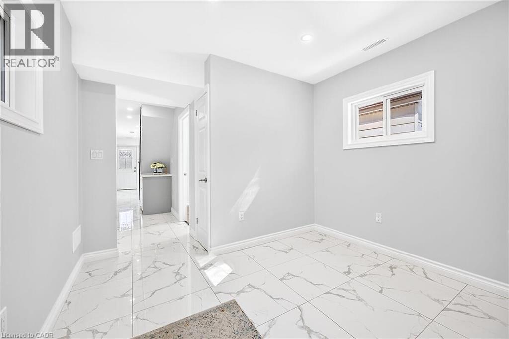 White-framed windows, recessed lighting, white baseboards, and light-toned walls - 4 Albemarle Street, Hamilton, ON