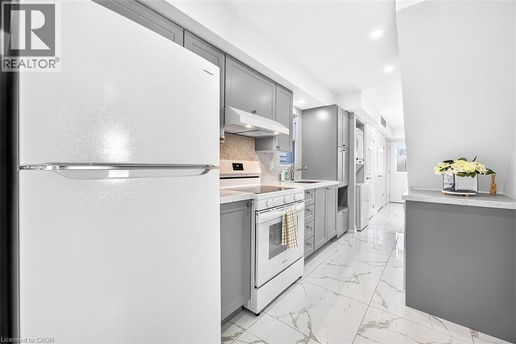 White appliances, gray cabinetry, light-toned backsplash, white marble-pattern flooring, and recessed ceiling lighting - 4 Albemarle Street, Hamilton, ON