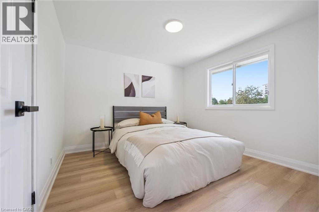 Bright room featuring light wood-finish flooring, white baseboards, and a contemporary flush-mount ceiling light - 299 Dale Crescent, Waterloo, ON