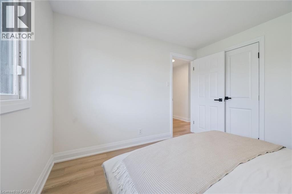 Interior room featuring light wood-finish flooring, white walls, and a single window with white trim - 299 Dale Crescent, Waterloo, ON