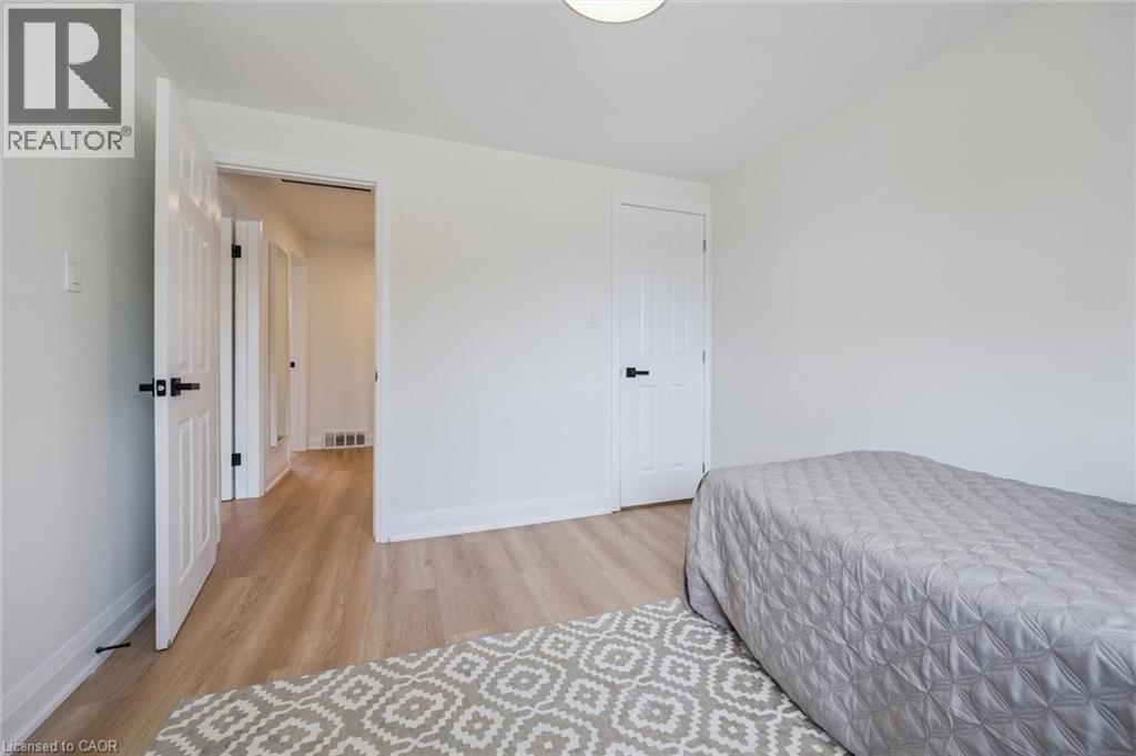 Bright room featuring light wood-finish flooring, white walls, and white trim - 299 Dale Crescent, Waterloo, ON