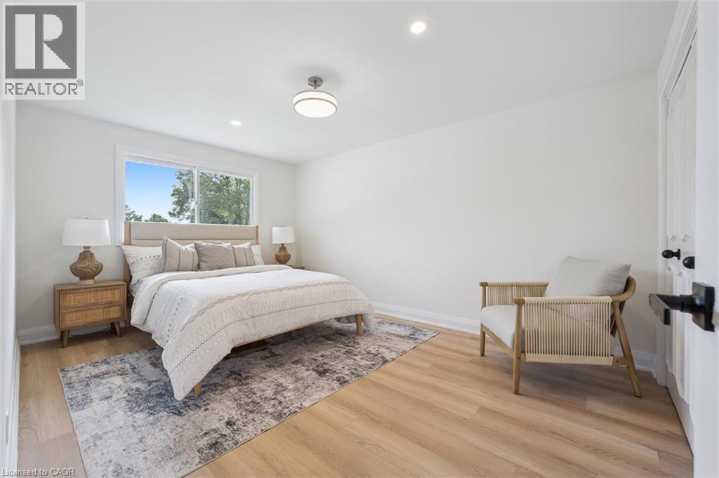 Bright interior space featuring light wood-finish flooring, white walls, and a window with outdoor scenery - 299 Dale Crescent, Waterloo, ON