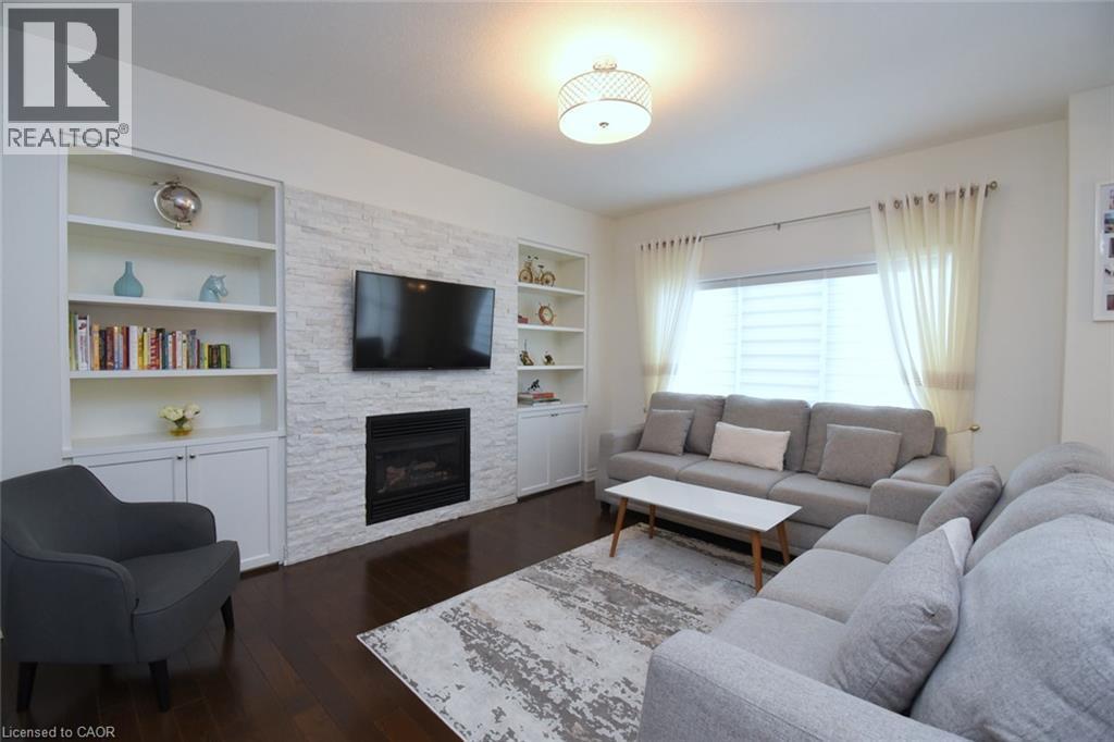 Built-in shelving flanking a stone-finish fireplace - 25 Guest Street, Hamilton, ON