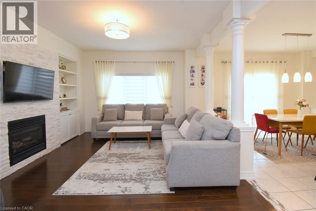 White stacked stone fireplace with built-in shelving - 25 Guest Street, Hamilton, ON