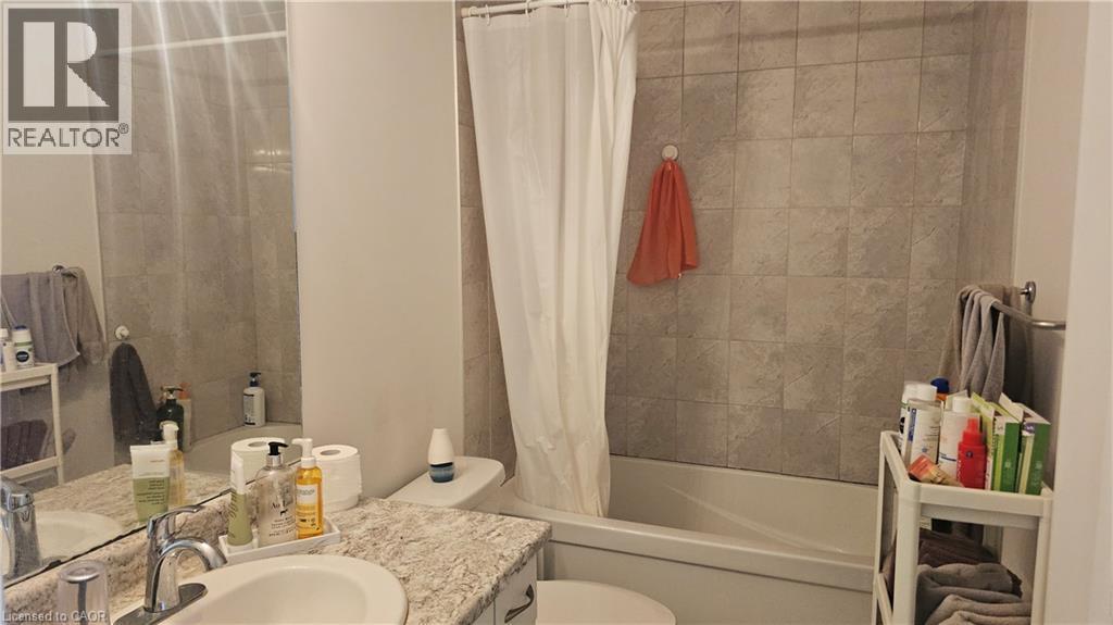 Bathtub with tile surround, vanity with single basin sink, and ample mirror - 3 Sharp Drive, Ancaster, ON