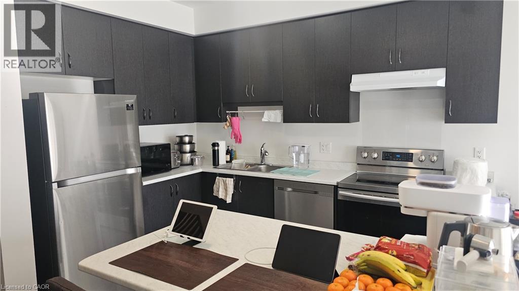 Modern kitchen featuring dark wood-finish cabinetry, white countertops, and stainless steel appliances including a refrigerator, range, and dishwasher - 3 Sharp Drive, Ancaster, ON