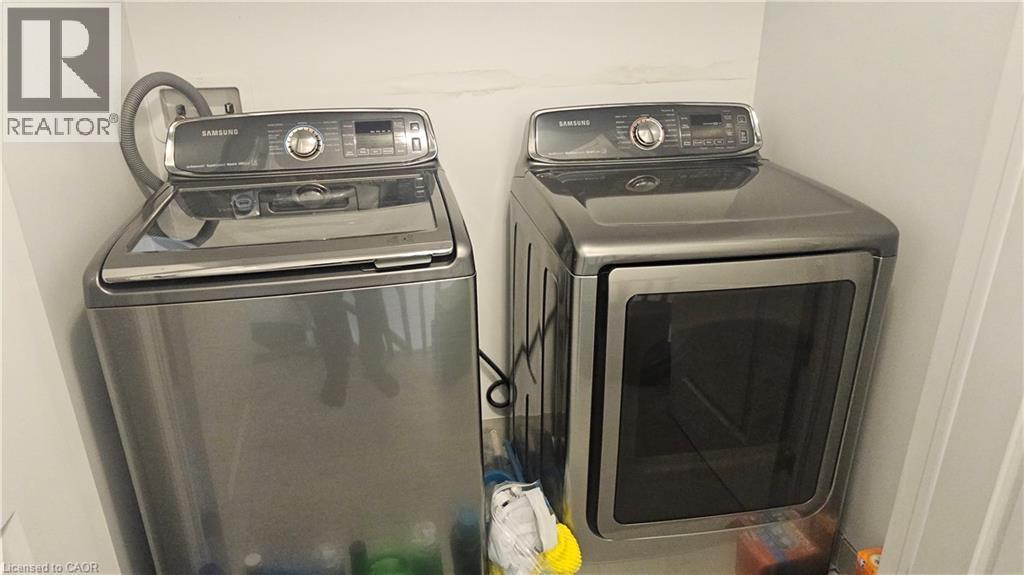 Built-in laundry appliances with a top-load washer and front-load dryer - 3 Sharp Drive, Ancaster, ON